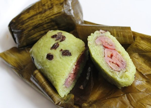 A close up of a banana leaf with a piece of food on it